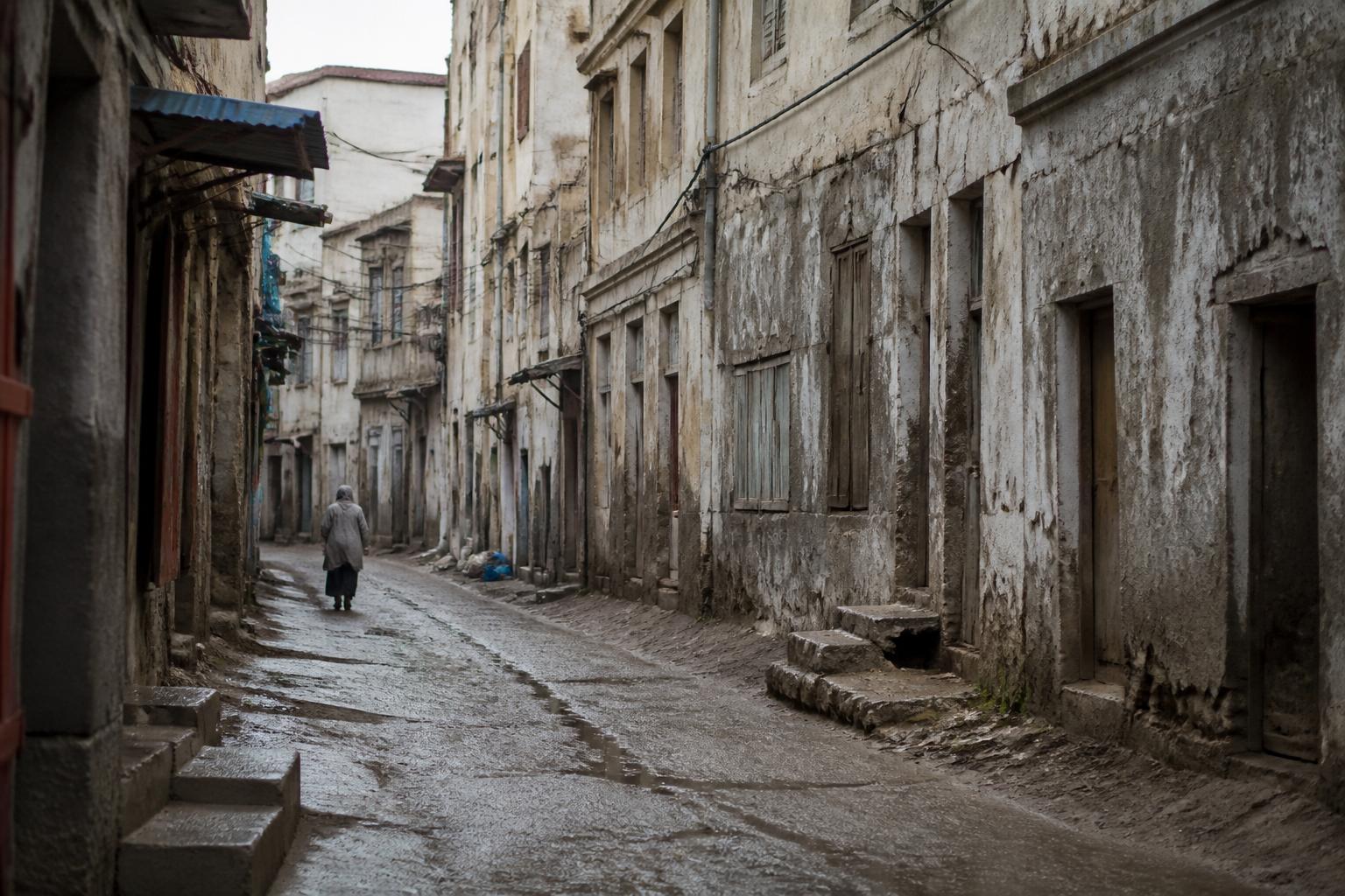 Rues degradees avec batiments delabres et facades grises